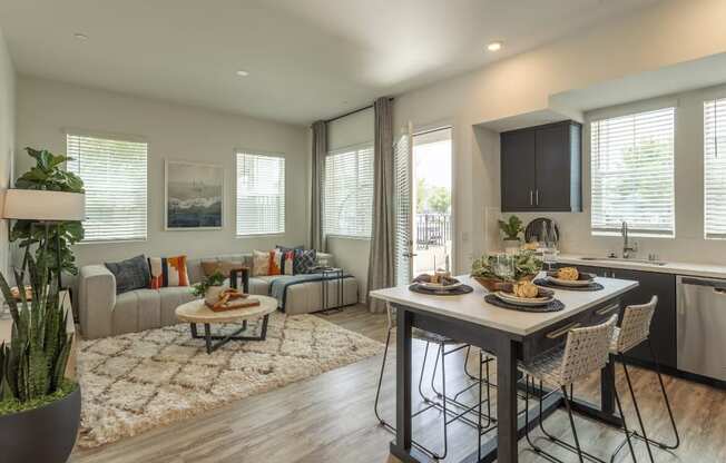 a living room and kitchen with a table and chairs