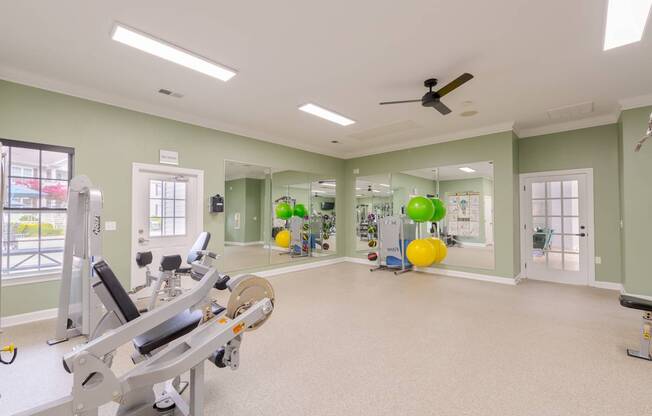 A spacious gym with a row of treadmills and exercise equipment.