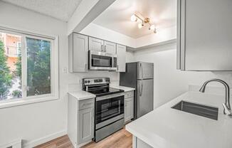 a kitchen with a stove top oven next to a window