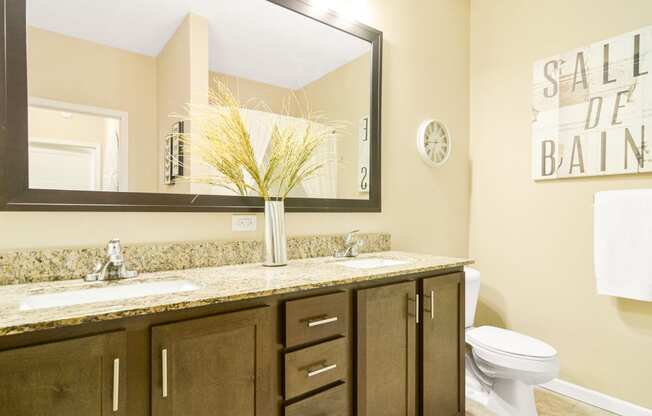 a bathroom with two sinks and a toilet