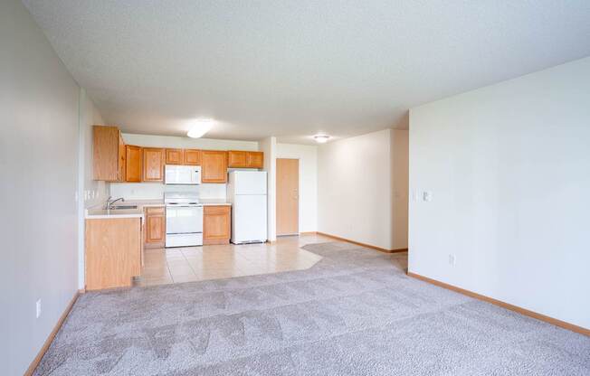 A kitchen with white appliances and wooden cabinets. Fargo, ND Stonebridge Apartments