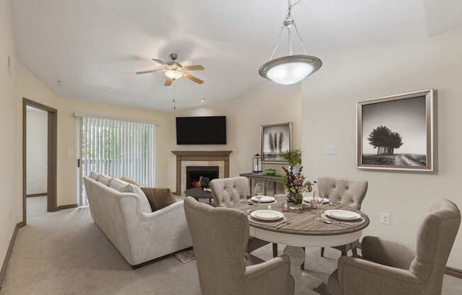 a living room with a table and chairs and a fireplace