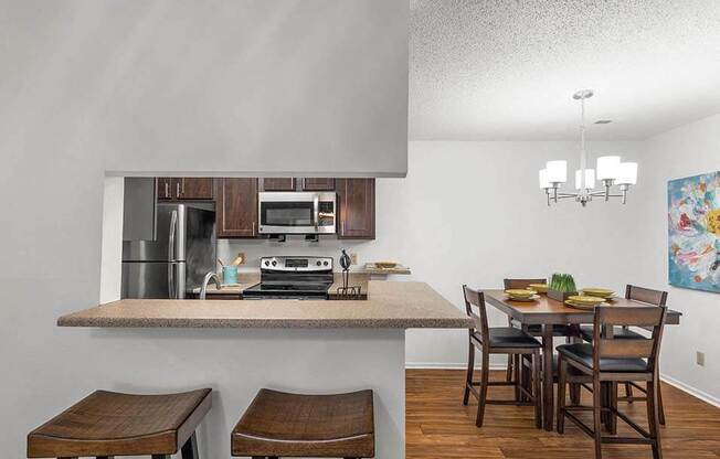 a kitchen with a bar and a dining table