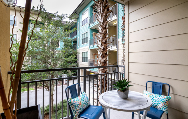 Private patio with railing overlooking Orland apartment community