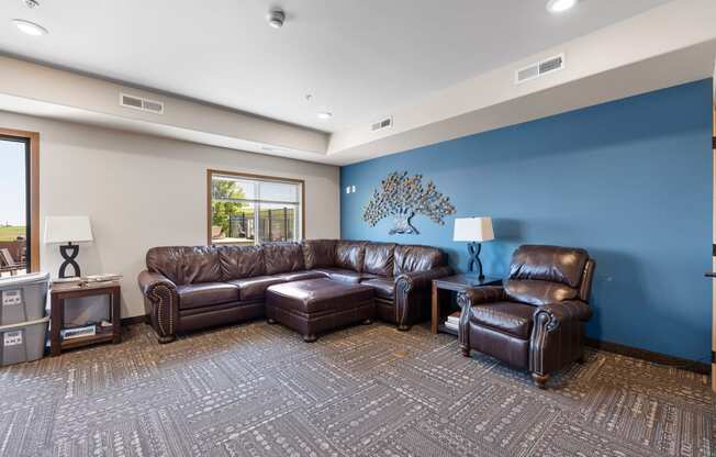 a large living room with leather couches and chairs