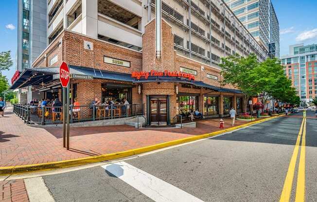 a street view of a restaurant on the corner of a city street