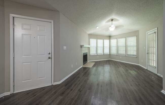 an empty living room with a fireplace