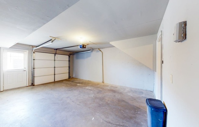 the inside of a garage with white walls and a white door