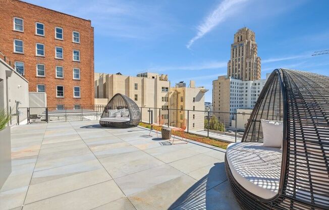 Rooftop lounge space with large pod chairs at TL Residences
