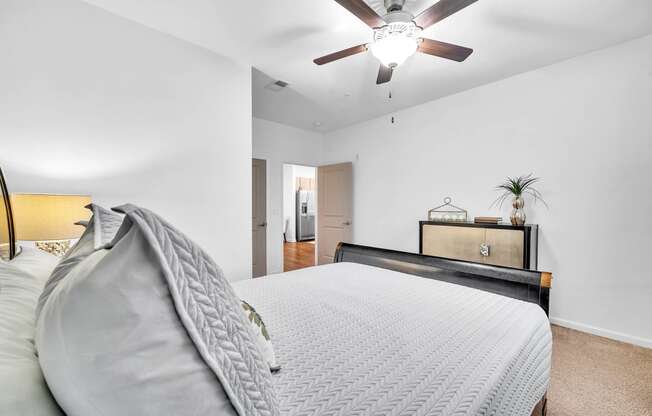 a bedroom with a large bed and a ceiling fan