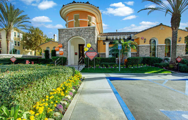 a walkway leading to a building with a round tower on top of it