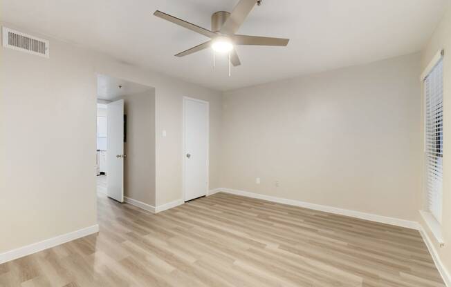 a bedroom with hardwood floors and a ceiling fan