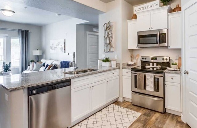Kitchen with stainless steel appliances and walk-in pantry