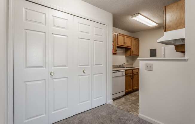 a kitchen with white doors and brown cabinets