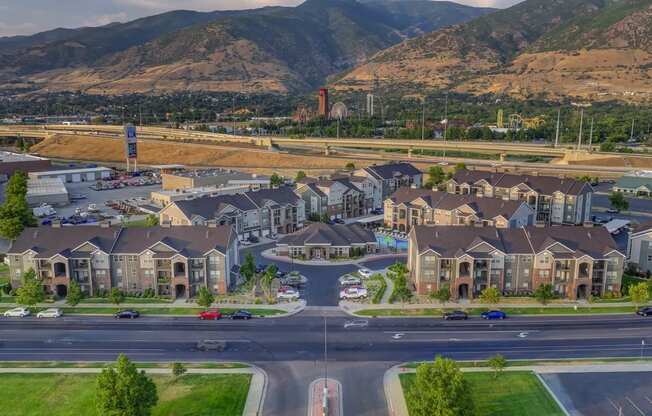 an aerial view of a neighborhood of houses with mountains in the background