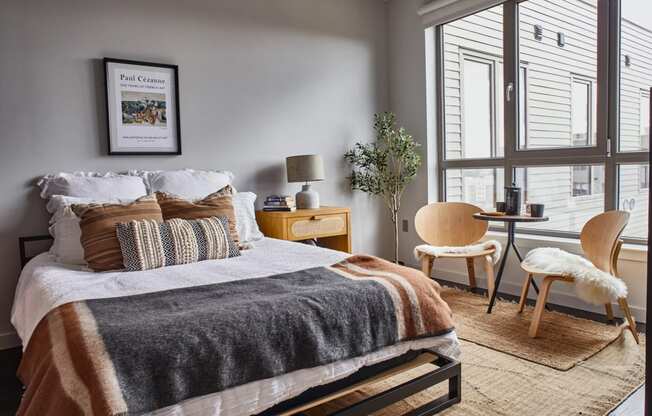 Bedroom with a bed and a large window at Sono Central Residential, Norwalk, CT