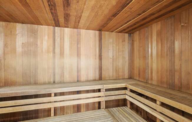 A wooden sauna with benches and walls.