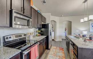 a kitchen with stainless steel appliances and granite counter tops