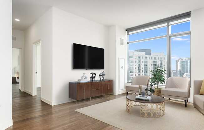a living room with a large window and a television at Cassidy on Canal, Chicago, Illinois