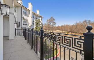 A black and white fence in front of a building.