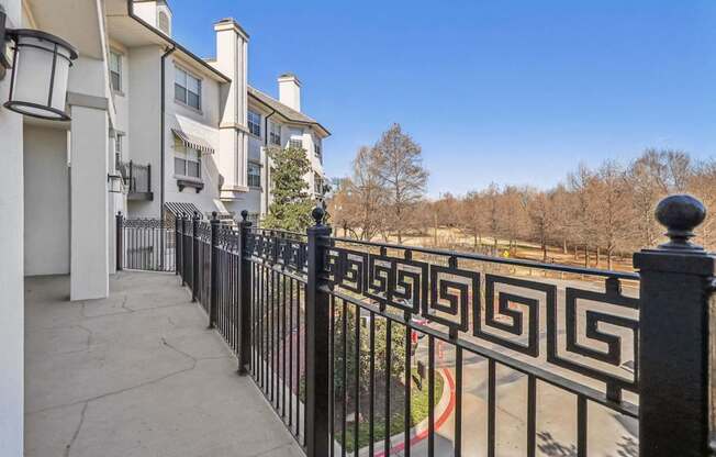 A black and white fence in front of a building.