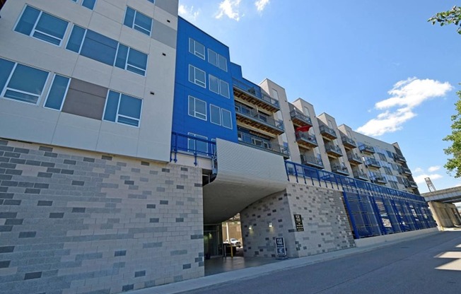 a large blue building with a street in front of it