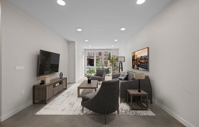 a living room with a gray couch and a tv