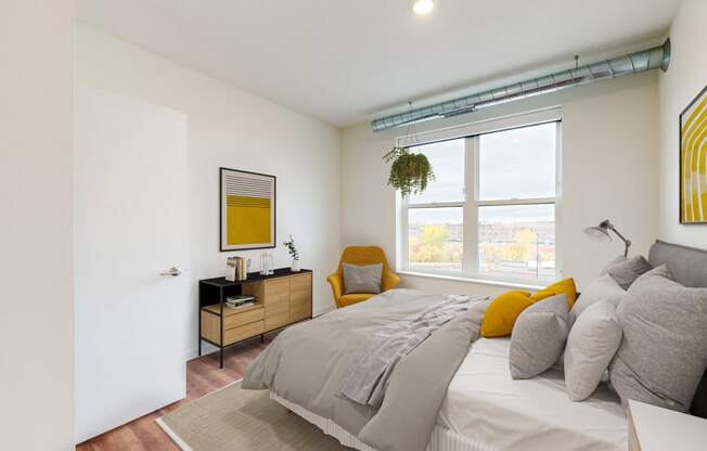 a bedroom with a large bed and a large window