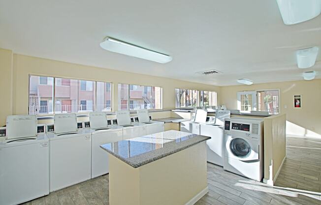 a laundry room with washers and dryers