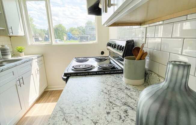 a kitchen with a marble counter top and a stove
