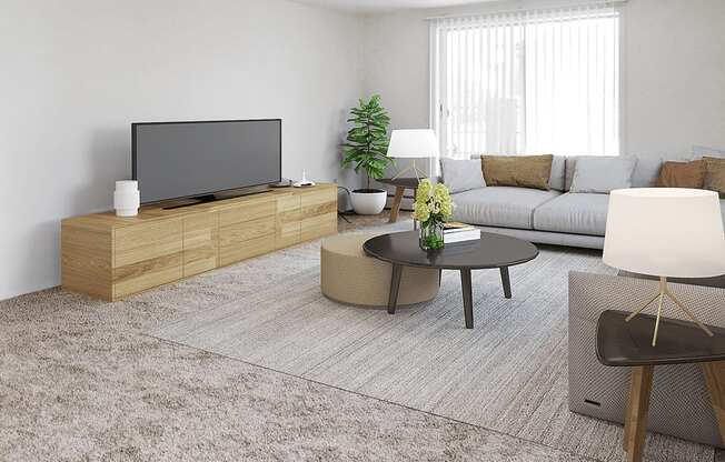 A modern living room with a flat screen TV, a coffee table, and a couch.