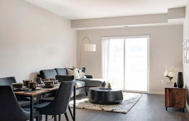 A modern dining room with a black table and chairs.
