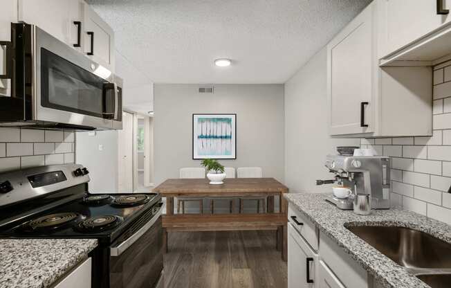 a kitchen and dining area in a 555 waverly unit