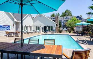 our apartments offer a swimming pool with tables and umbrellas