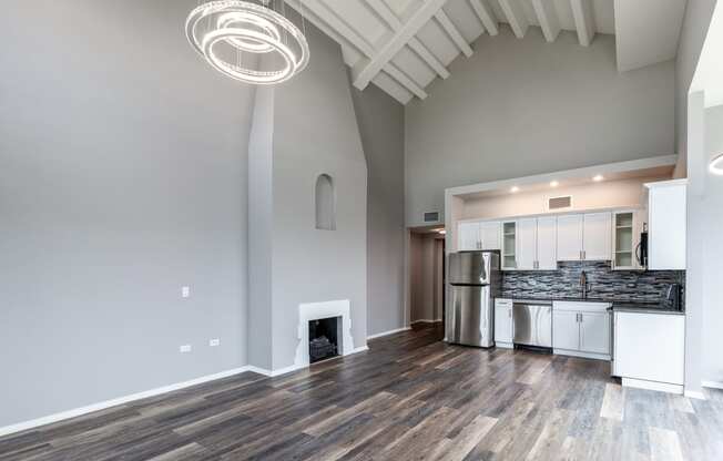 a living room with a fireplace and a kitchen
