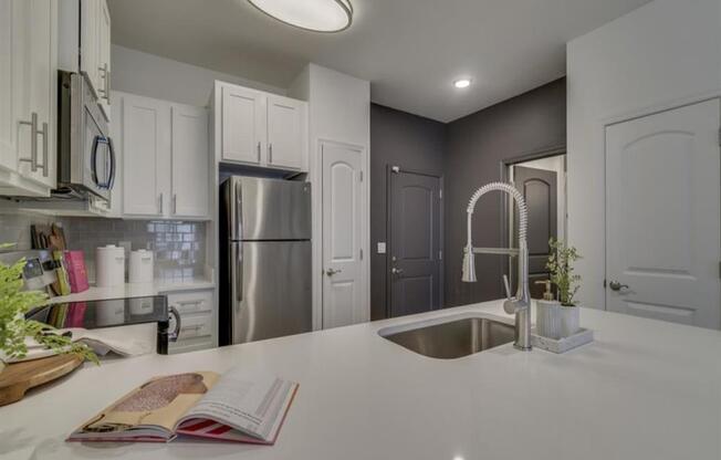 a kitchen with a sink and a refrigerator at Flats at West Broad Village, Virginia, 23060