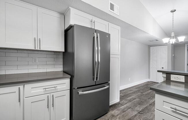 a large white refrigerator in a kitchen