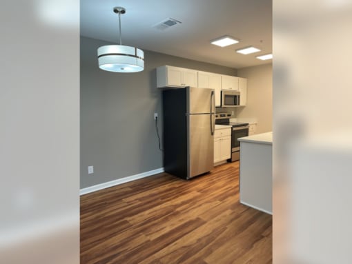 a view of a kitchen with a stainless steel refrigerator and