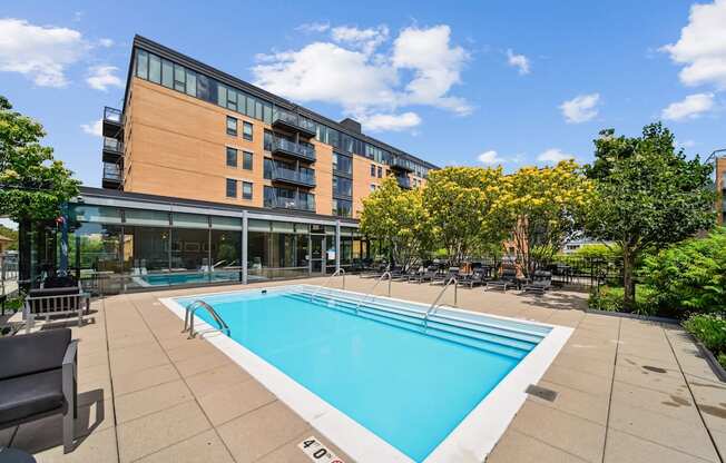 A swimming pool in a sunny outdoor pool area.