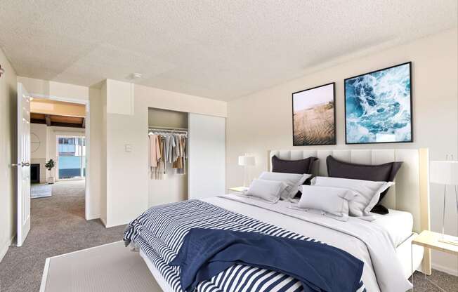 A renovated bedroom with a large bed and a Wall Art at  Foster Creek apartments in Tukwila, WA