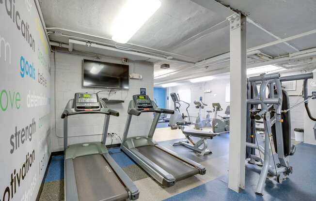 Fitness center with treadmills at Mason Hall in Alexandria, VA 22314