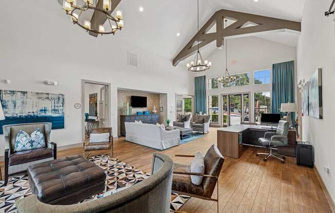 A large, well-furnished living room with a variety of seating options and a chandelier.