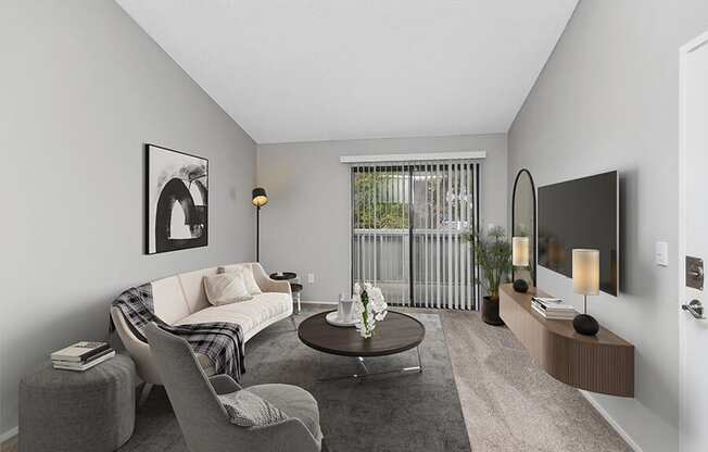 Model Living Room with Carpet and Patio Accessibility at The Meritage Apartments in Vallejo, CA.