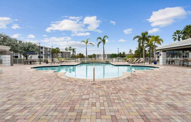 a swimming pool at a resort with palm trees