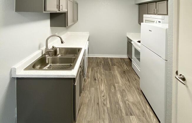 a kitchen with a sink and a mirror