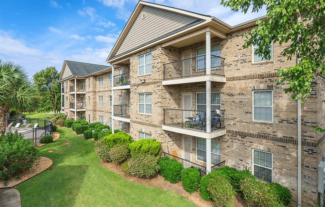 Apartment building with a green lawn in front.