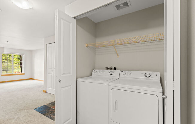 A white washer and dryer in a laundry room.