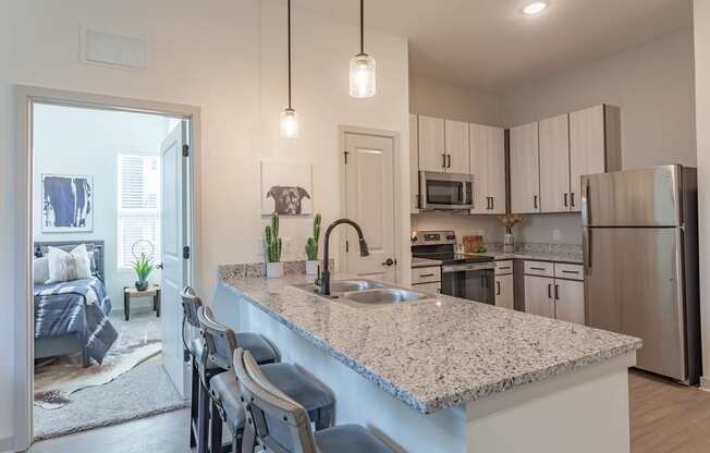 a kitchen with white cabinets and a granite counter top