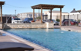 a swimming pool with a gazebo on the side of a hotel pool