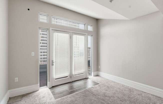 A room with a carpeted floor and a sliding door.